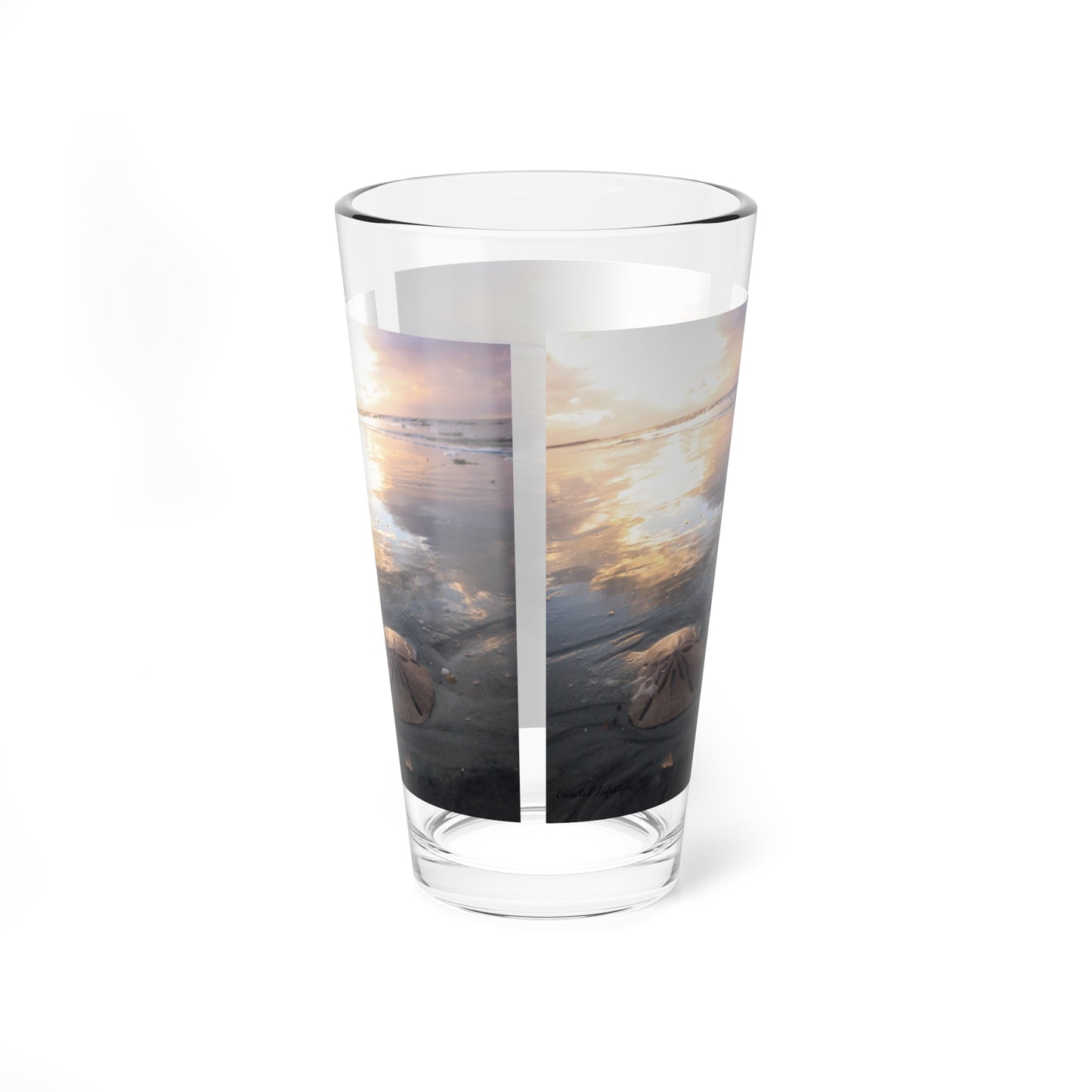 Mixing or table glass, sunrise, sand, and sand dollar beach scene