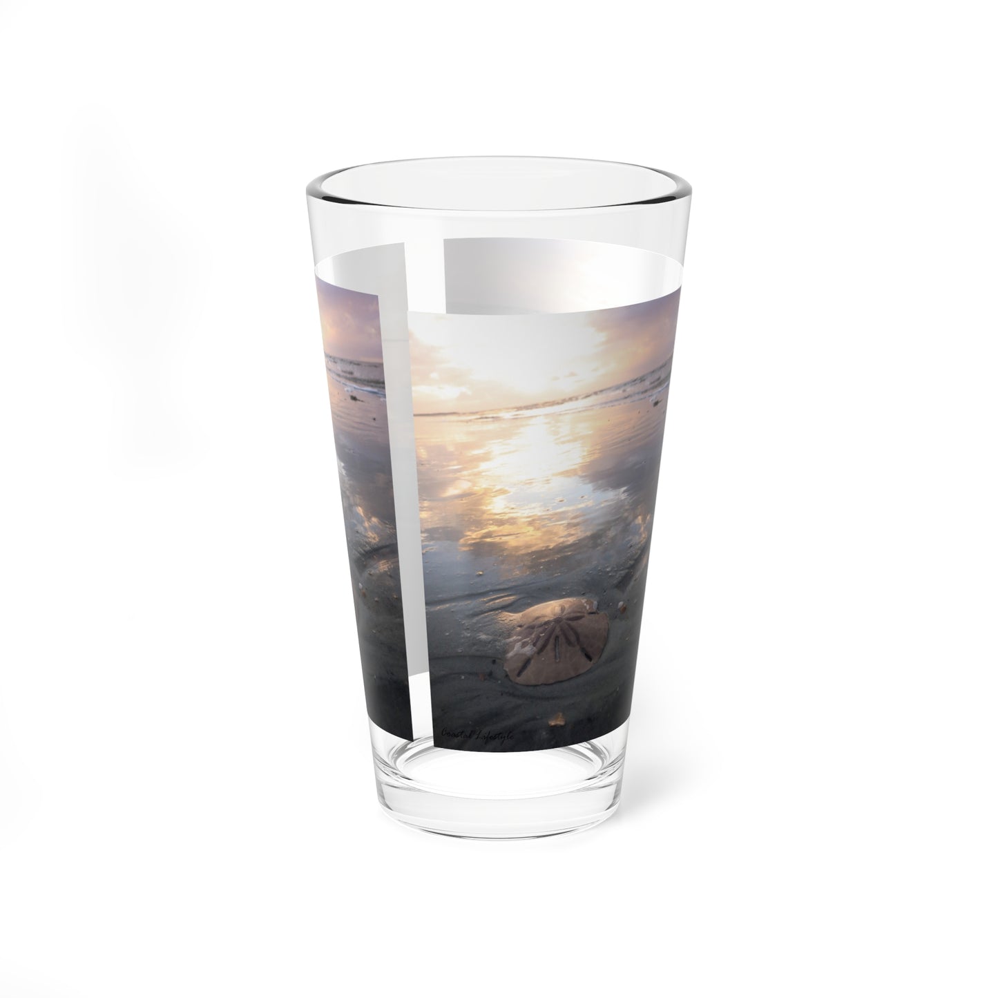 Mixing or table glass, sunrise, sand, and sand dollar beach scene