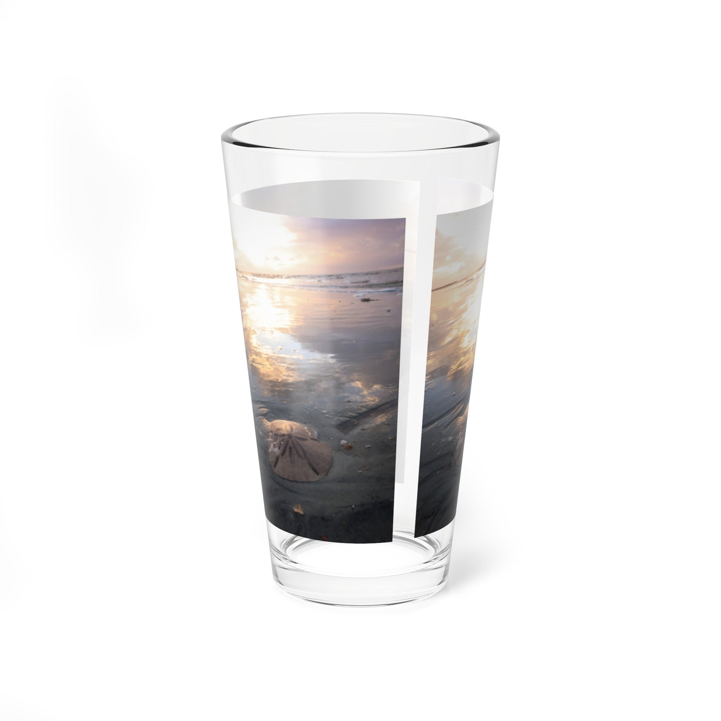 Mixing or table glass, sunrise, sand, and sand dollar beach scene